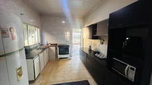 a kitchen with a sink and a refrigerator at Casa California - espaçosa in Formosa