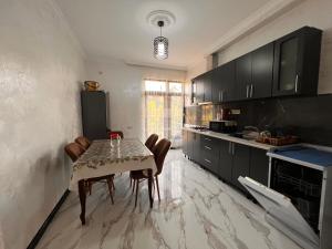 a kitchen with a table and chairs in a room at vila in CHAKVI in Chakvi