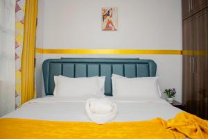 a bed with a hat on top of it at executive home in Eldoret