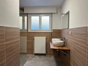 a bathroom with a sink and a window at Le Repère De lAigle - Vue Panoramique in Cornimont +9 photos