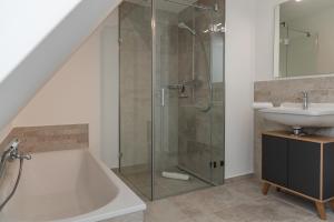 a bathroom with a shower and a sink at Friesenfrühling in Borgsum +24 photos