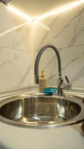 a kitchen sink with a faucet on top of it at Apartman M&Ð Foca-free parking garage in Foča +27 photos