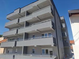 an external view of a building with balconies at Apartman M&Ð Foca-free parking garage in Foča