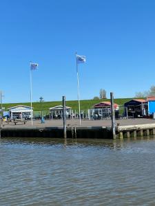 a dock with a marina with buildings in the background at Ferienwohnung bi Klatt tu Hus in Wremen