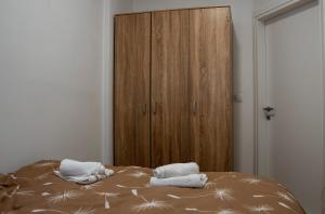 a bedroom with a bed with towels on it at Apartman M&Ð Foca-free parking garage in Foča