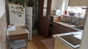 a kitchen with a white refrigerator and a sink at J&K Štrba in Poprad