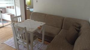 a living room with a table and a couch at J&K Štrba in Poprad +8 photos
