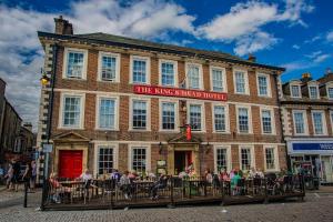a group of people sitting outside of a building at The Kings Head Hotel, Richmond, North Yorkshire - The Coaching Inn Group in Richmond