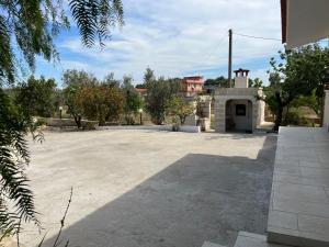 a large parking lot with a building in the background at Villa Mina in Serranova