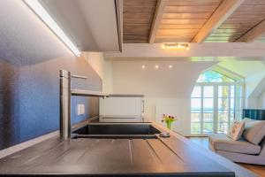 a kitchen with a stove top oven in a room at Ferienwohnung Stöfs in Behrensdorf