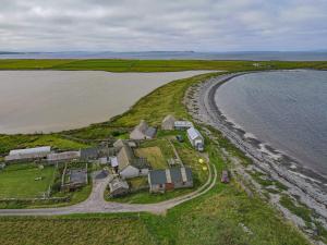 an aerial view of a house next to the beach at Accommodation by the sea on Sanday in Orkney