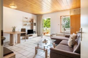 a living room with a couch and a table at Ferienhäuser Ella Walter - Efeuhaus in Nordstrand