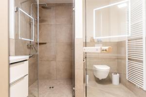 a bathroom with a toilet and a glass shower door at Strandläufer 1 4 - Kellenhusen in Kellenhusen +43 photos