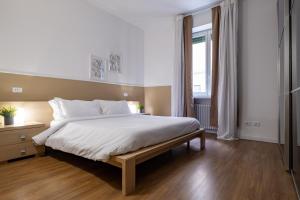 a bedroom with a large bed and a window at Leoncino Apartment in Verona