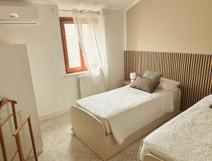 a bedroom with two beds and a window at Casa Vacanze Francesca in Mondolfo