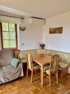 a living room with a table and a couch at Apartma Marjetica 47 in Moravske-Toplice