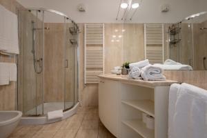 a bathroom with a shower and a toilet and a sink at Leoncino Apartment in Verona +9 photos