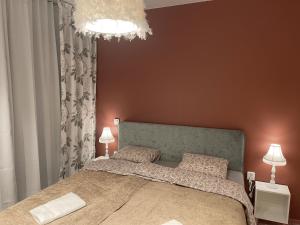 a bedroom with a large bed and a chandelier at Hotell Vänersborg in Vänersborg