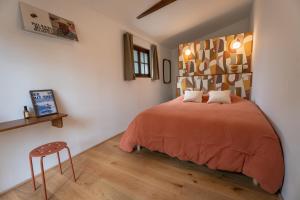 a bedroom with a bed and a wooden floor at Brume Surf House in Messanges +34 photos