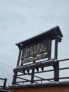 a sign for a hotel ill chino restaurant on top of a building at hotel il ghiro in Ovindoli