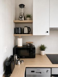 a kitchen with a black microwave and a counter top at Hauda in Sopelana