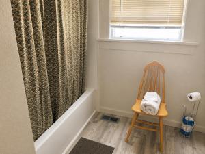 a chair in a room with a shower curtain at Mt Shasta Basecamp in Dunsmuir