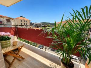 a balcony with a table and potted plants on it at Hauda in Sopelana