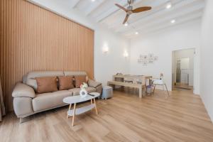 a living room with a couch and a table at The Urban478 Modern&Cozy Stay in Bangkok