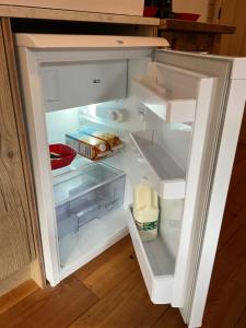 an open refrigerator with some food in it at Oak ridge cabin in Norwich