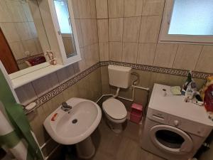 a small bathroom with a toilet and a sink at Kuća za pravi odmor in Kolašin +13 photos