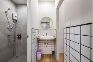 a bathroom with a sink and a shower and a mirror at The Urban478 Modern&Cozy Stay in Bangkok +64 photos