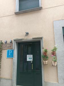 a door to a building with potted plants on it at ACUBILLO in Palas de Rei