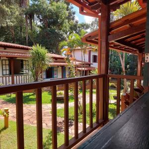 a view from the porch of a house with a wooden railing at Pousada Vila Cocais in Cocais