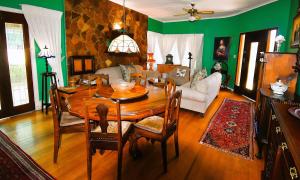 a dining room with a table and a living room at Beau & I in Graaff-Reinet