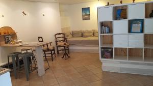 a living room with a table and a couch at La chambre d'hôtes du moulin de Vignars in Ginals