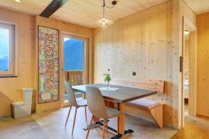 a dining room with a wooden table and chairs at Felderhof in Villa Ottone