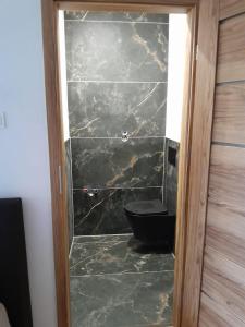 a bathroom with a black toilet in a room at U Mariki in Mikoszowa +23 photos
