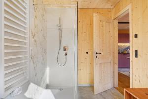 a bathroom with a shower with a glass door at Felderhof in Villa Ottone +30 photos