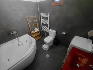 a bathroom with a tub and a toilet and a sink at Vista Mare in Nea Irakleia +61 photos