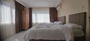 a bedroom with a large white bed and a window at Blue Amedist Hotel in Istanbul