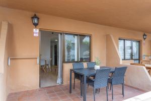a patio with a table and chairs in a house at Casa Oasis in Corralejo