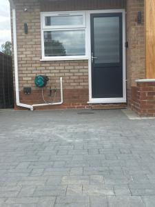 a house with a black door and a window at Holyport Studio flat in Bray