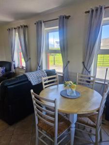 a living room with a table and a couch at Lakeside cottage in Valley