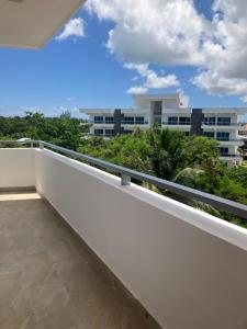 a balcony with a view of a building at One suite los corales in Punta Cana