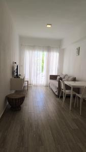 a living room with a couch and a table at One suite los corales in Punta Cana +6 photos