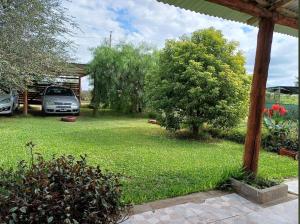 a yard with a car parked in the yard at Casa de campo - PetFriendly in Concepción del Uruguay +3 photos