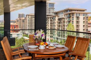 a table on a balcony with a view of a city at Meroddi Beyoğlu Residence in Istanbul