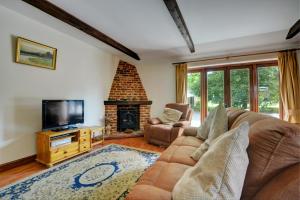 a living room with a couch and a fireplace at 2 Bed in Lyng oc-864 in Lyng