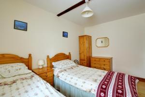 a bedroom with two beds and wooden furniture at 2 Bed in Lyng oc-864 in Lyng