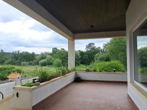 an empty porch with a view of a garden at Quinta dos Choupos in Coimbra